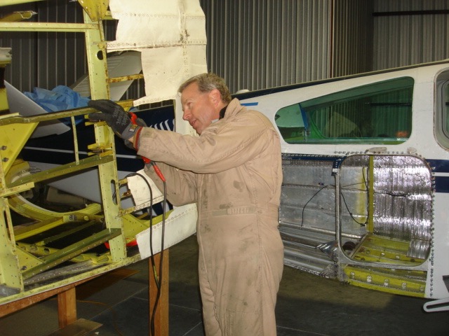 Removing parts form large baggage door installation. 
